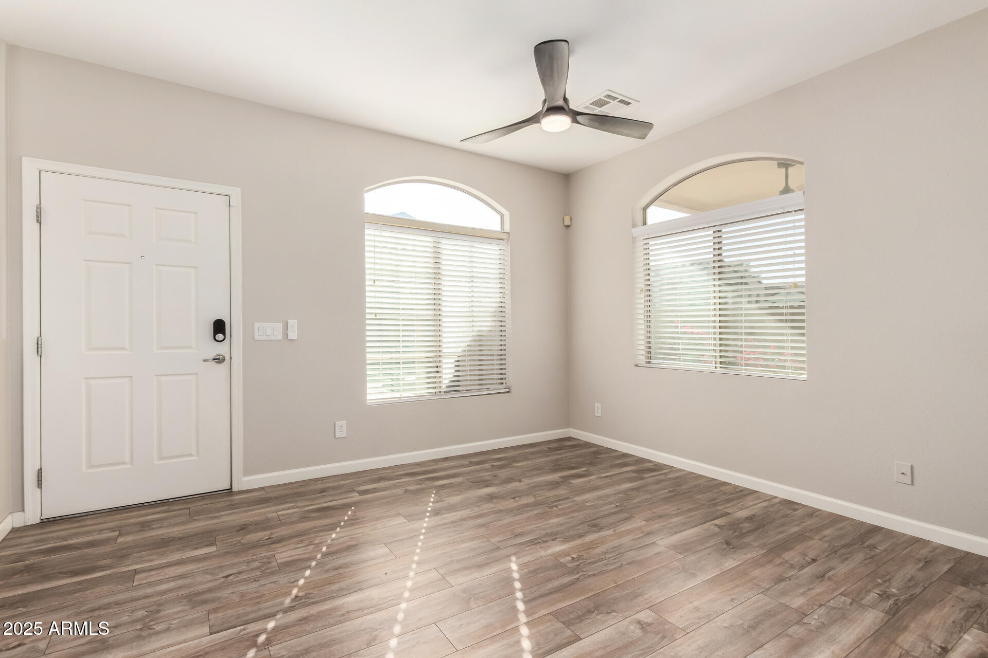 2725 East Mine Creek Road, Unit 1010 Phoenix, AZ 85024 - Photo 4 of 35 wooden floor in an empty room with a window