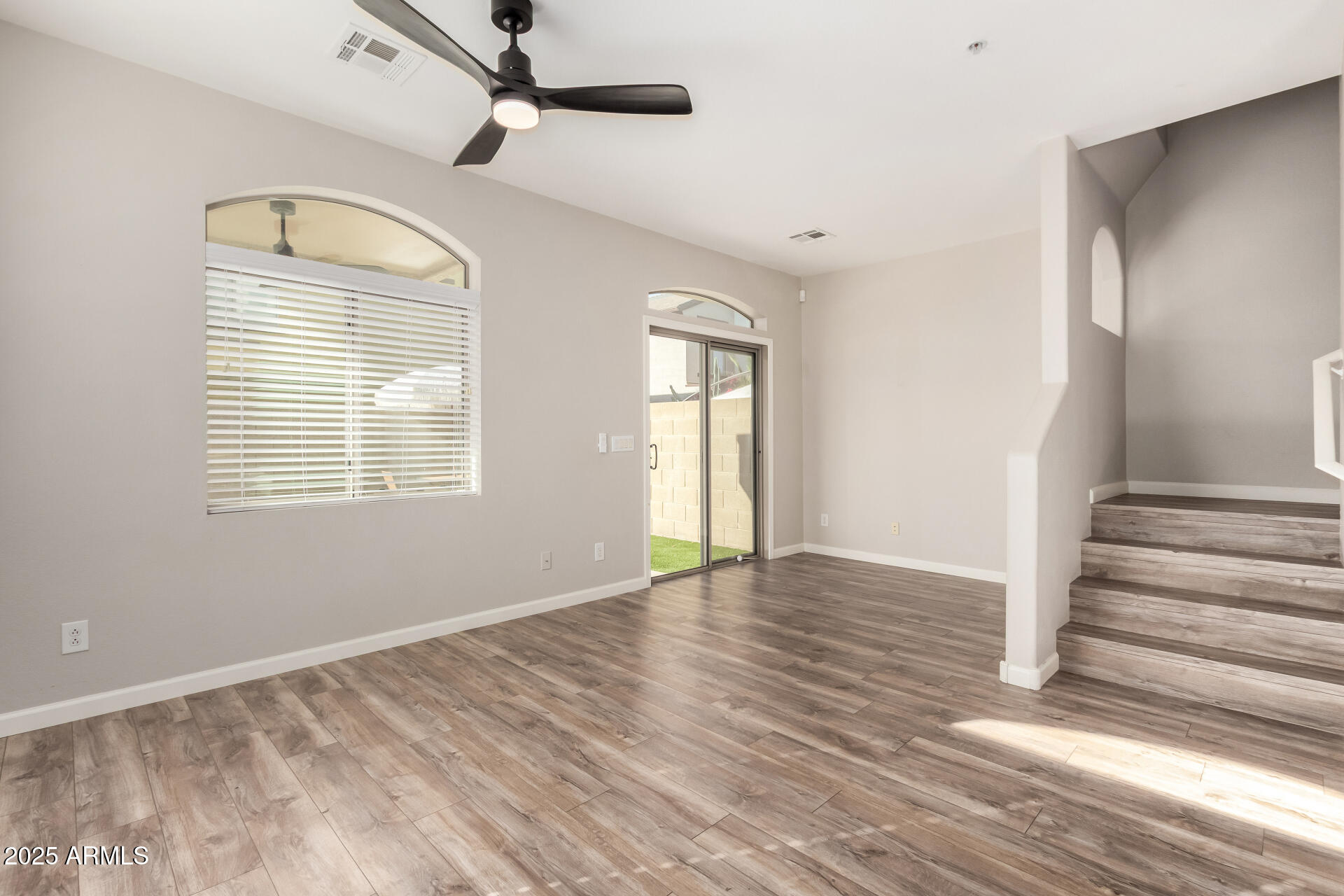 2725 East Mine Creek Road, Unit 1010 Phoenix, AZ 85024 - Photo 5 of 35 a view of an empty room with wooden floor and a window