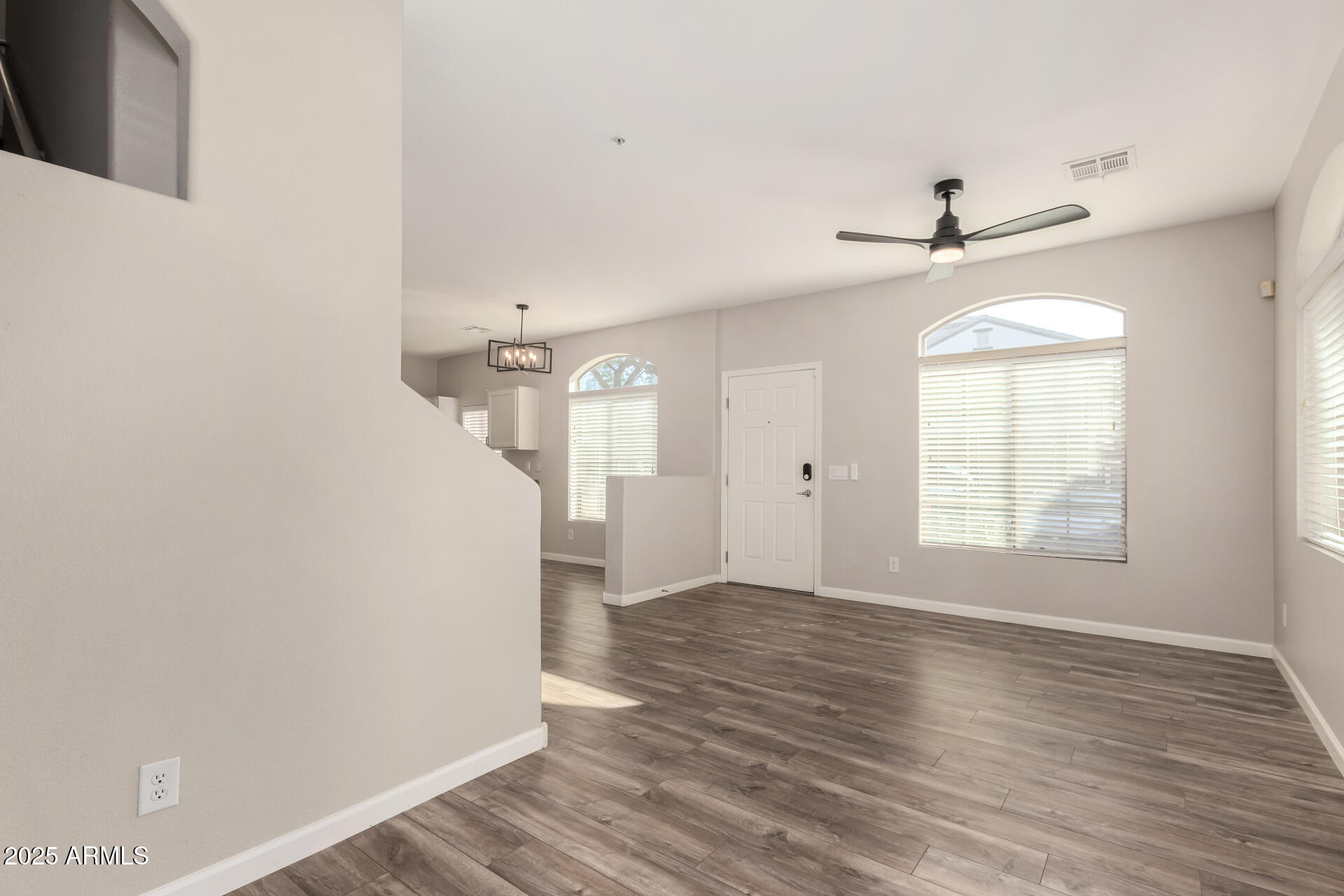 2725 East Mine Creek Road, Unit 1010 Phoenix, AZ 85024 - Photo 6 of 35 a view of empty room with wooden floor and fan