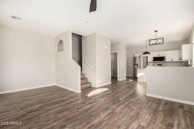 a view of a kitchen with furniture and wooden floor