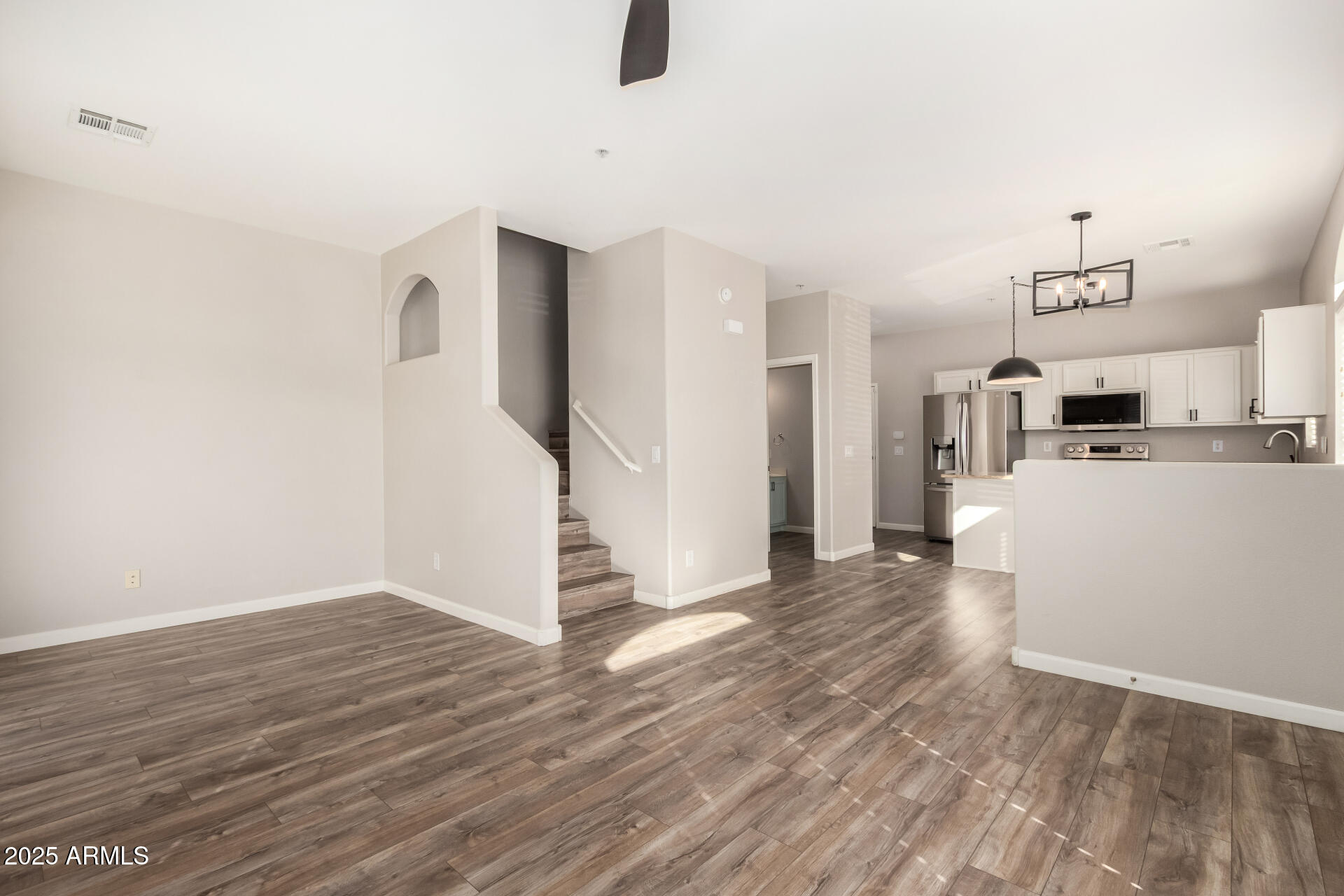2725 East Mine Creek Road, Unit 1010 Phoenix, AZ 85024 - Photo 7 of 35 a view of a kitchen with furniture and wooden floor