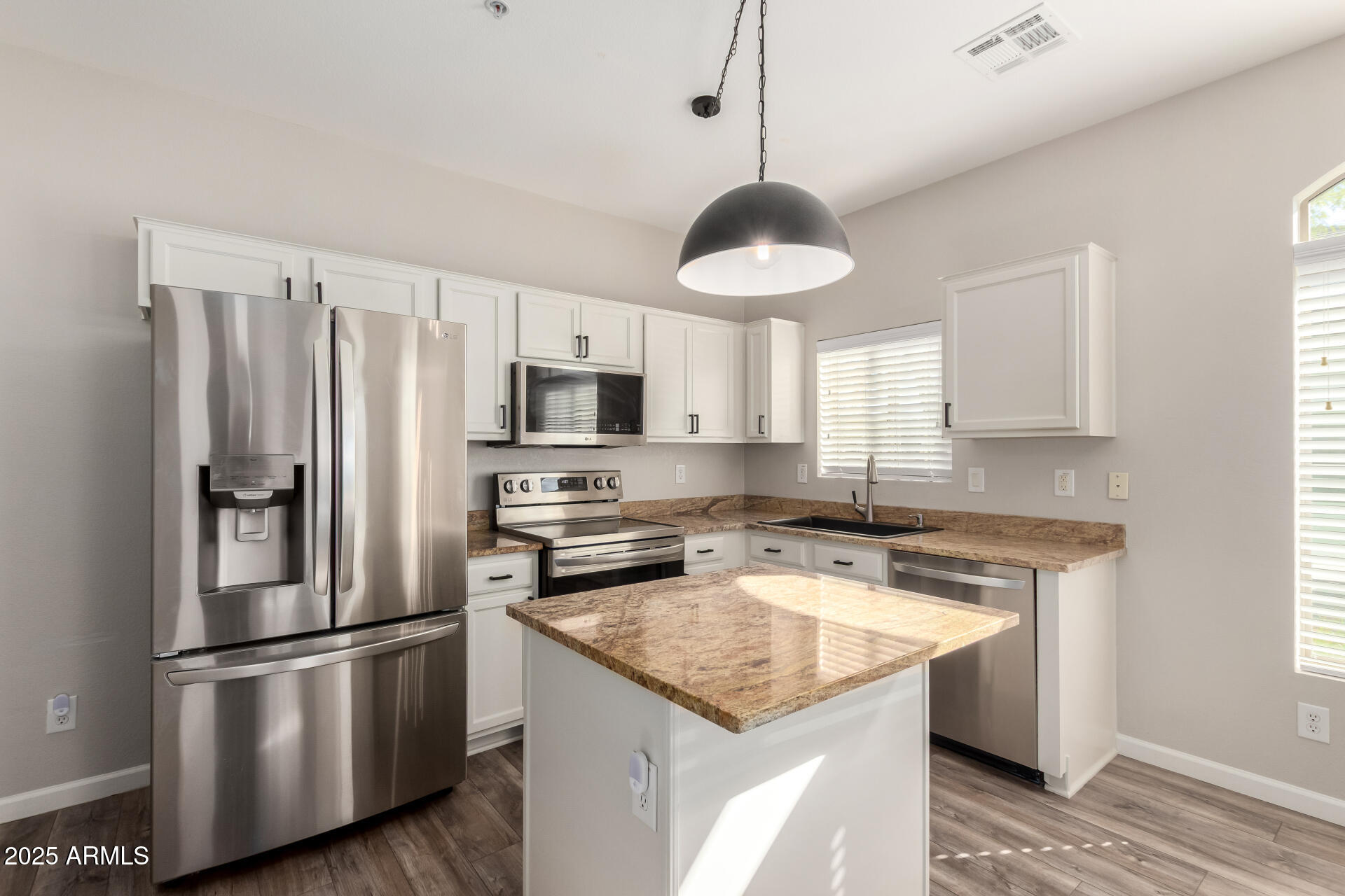 2725 East Mine Creek Road, Unit 1010 Phoenix, AZ 85024 - Photo 8 of 35 a kitchen with stainless steel appliances granite countertop a sink a stove a refrigerator and island