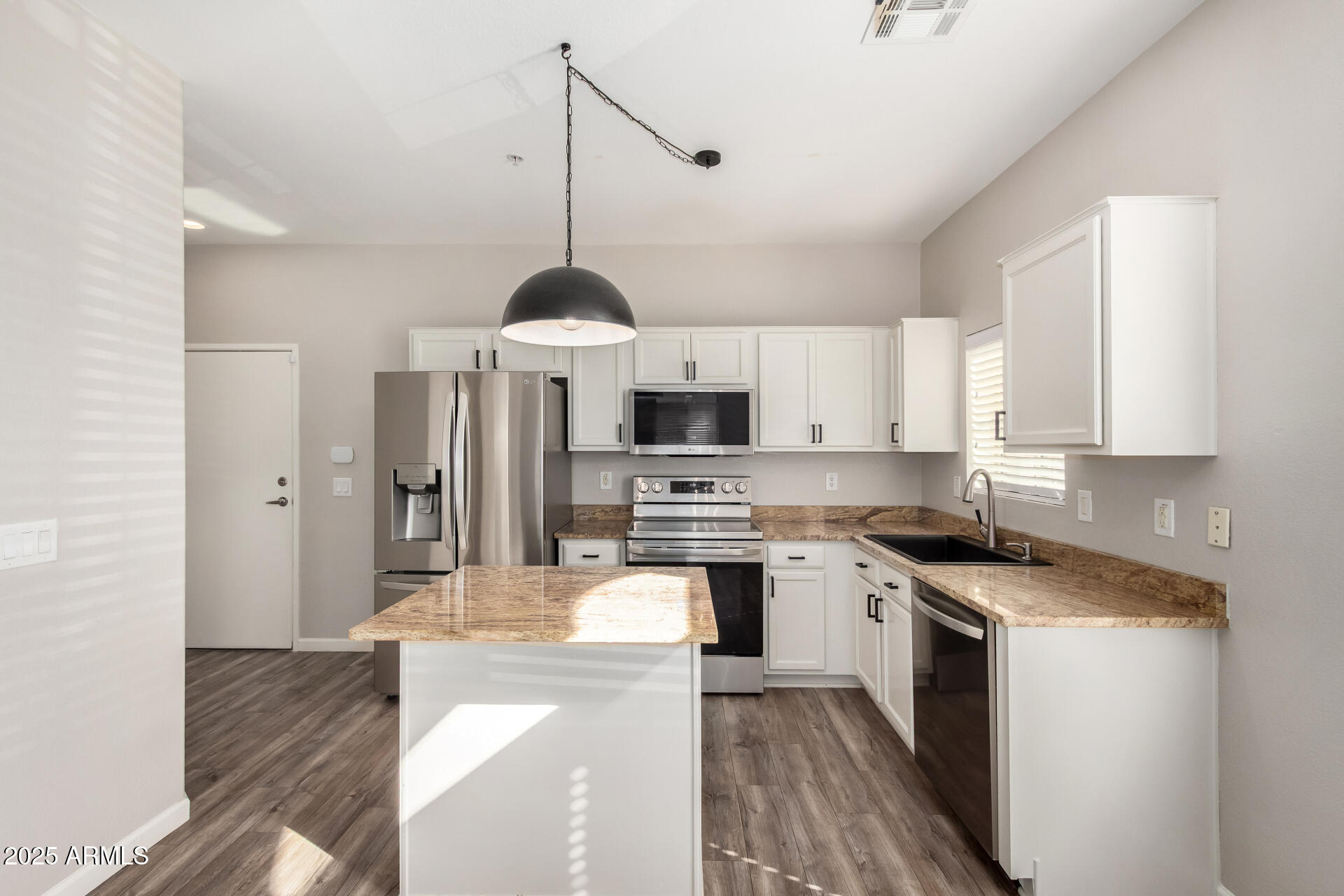 2725 East Mine Creek Road, Unit 1010 Phoenix, AZ 85024 - Photo 9 of 35 a kitchen with stainless steel appliances granite countertop a stove top oven a sink a refrigerator and white cabinets with wooden floor