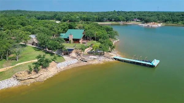 an aerial view of a houses with a lake view
