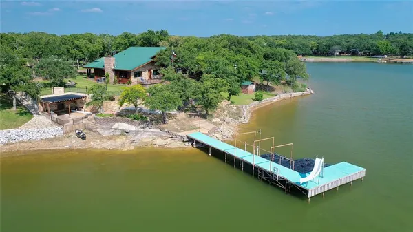 an aerial view of a house with a lake view
