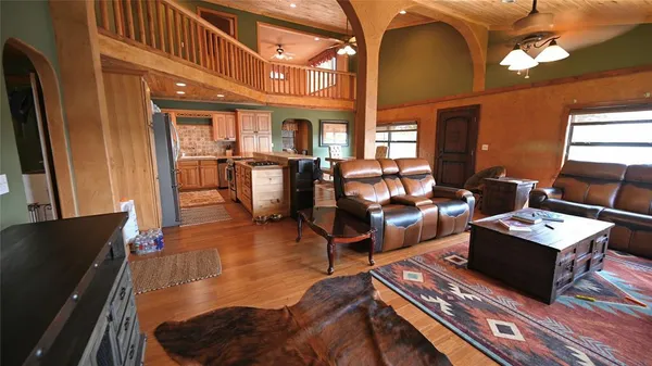 a living room with furniture a rug and a piano