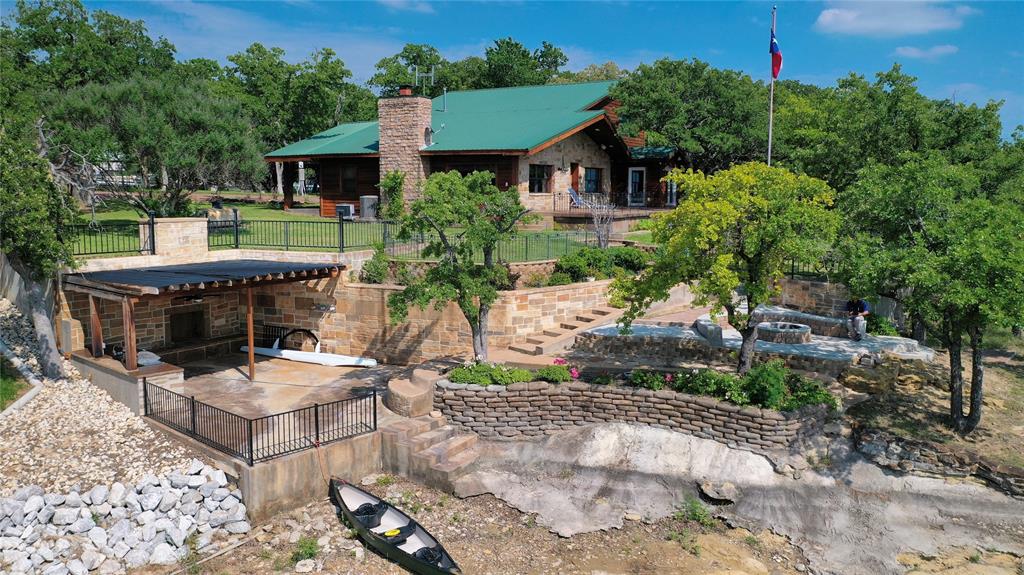 2377 Casino Road Nocona, TX 76255 - Photo 3 of 40 a view of a patio with table and chairs potted plants and large tree