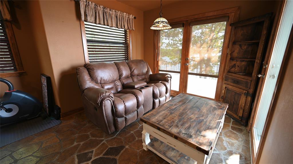 2377 Casino Road Nocona, TX 76255 - Photo 33 of 40 a living room with furniture and a floor to ceiling window