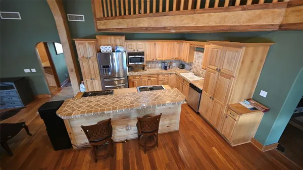 a dining room with furniture and wooden floor