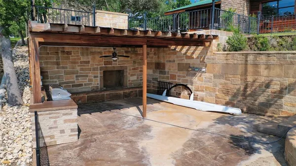 a view of a terrace with furniture and a fireplace