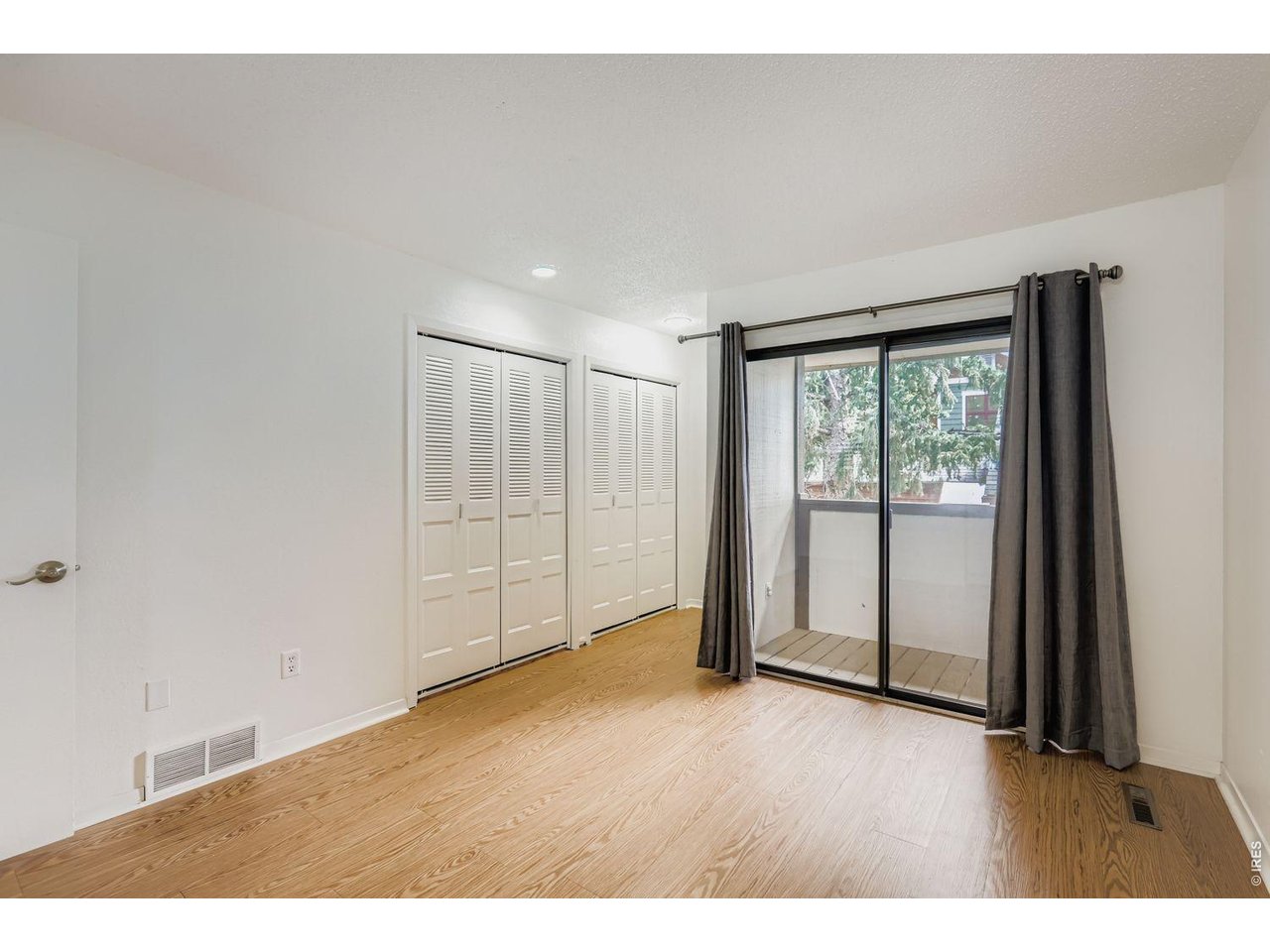 720 17th Street Boulder, CO 80302 - Photo 12 of 35 a view of an empty room with wooden floor and a window