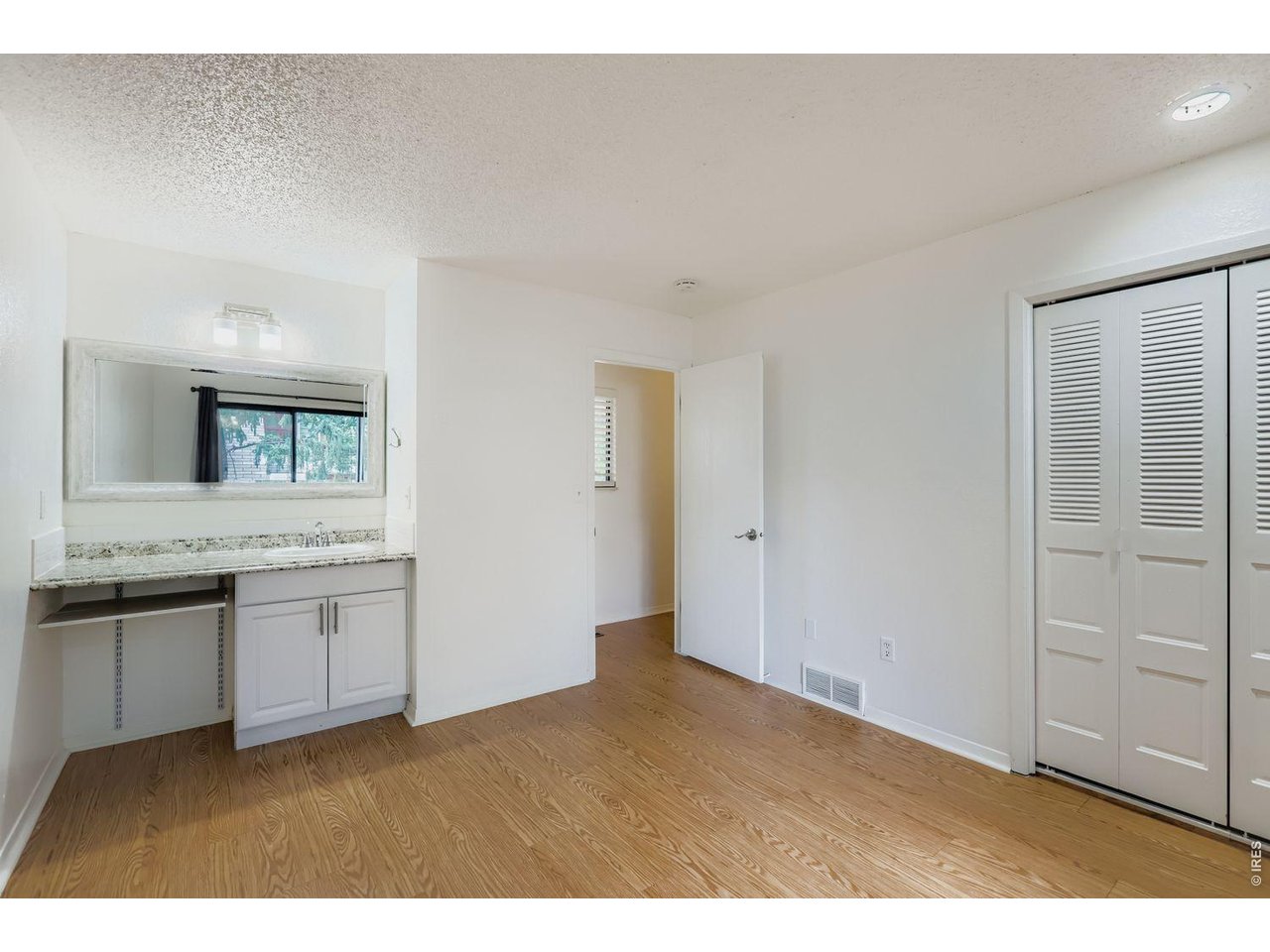 720 17th Street Boulder, CO 80302 - Photo 13 of 35 a bathroom with a granite countertop sink and mirror
