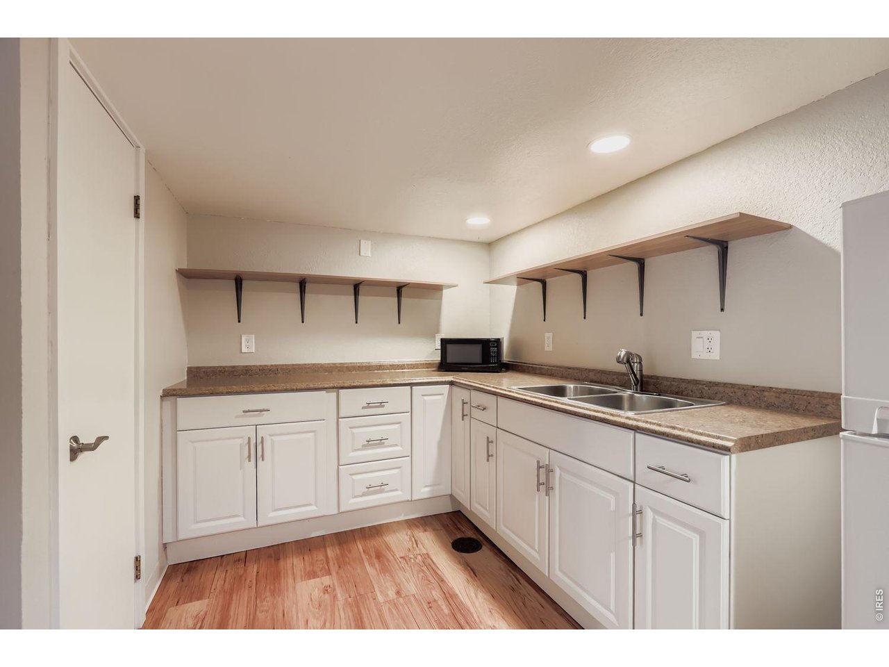 720 17th Street Boulder, CO 80302 - Photo 21 of 35 a kitchen with granite countertop a sink and cabinets
