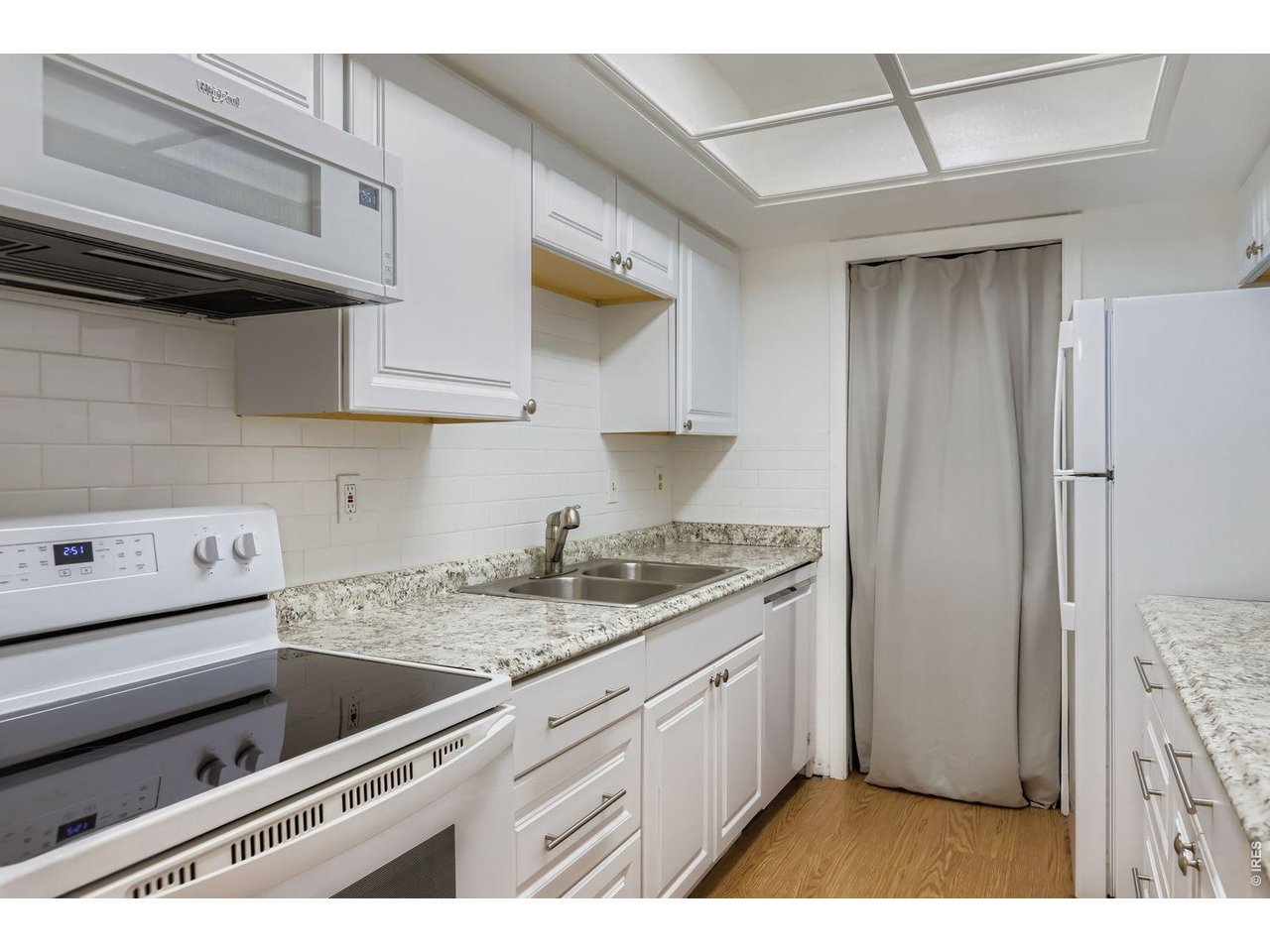 720 17th Street Boulder, CO 80302 - Photo 6 of 35 a kitchen with a sink dishwasher and cabinets