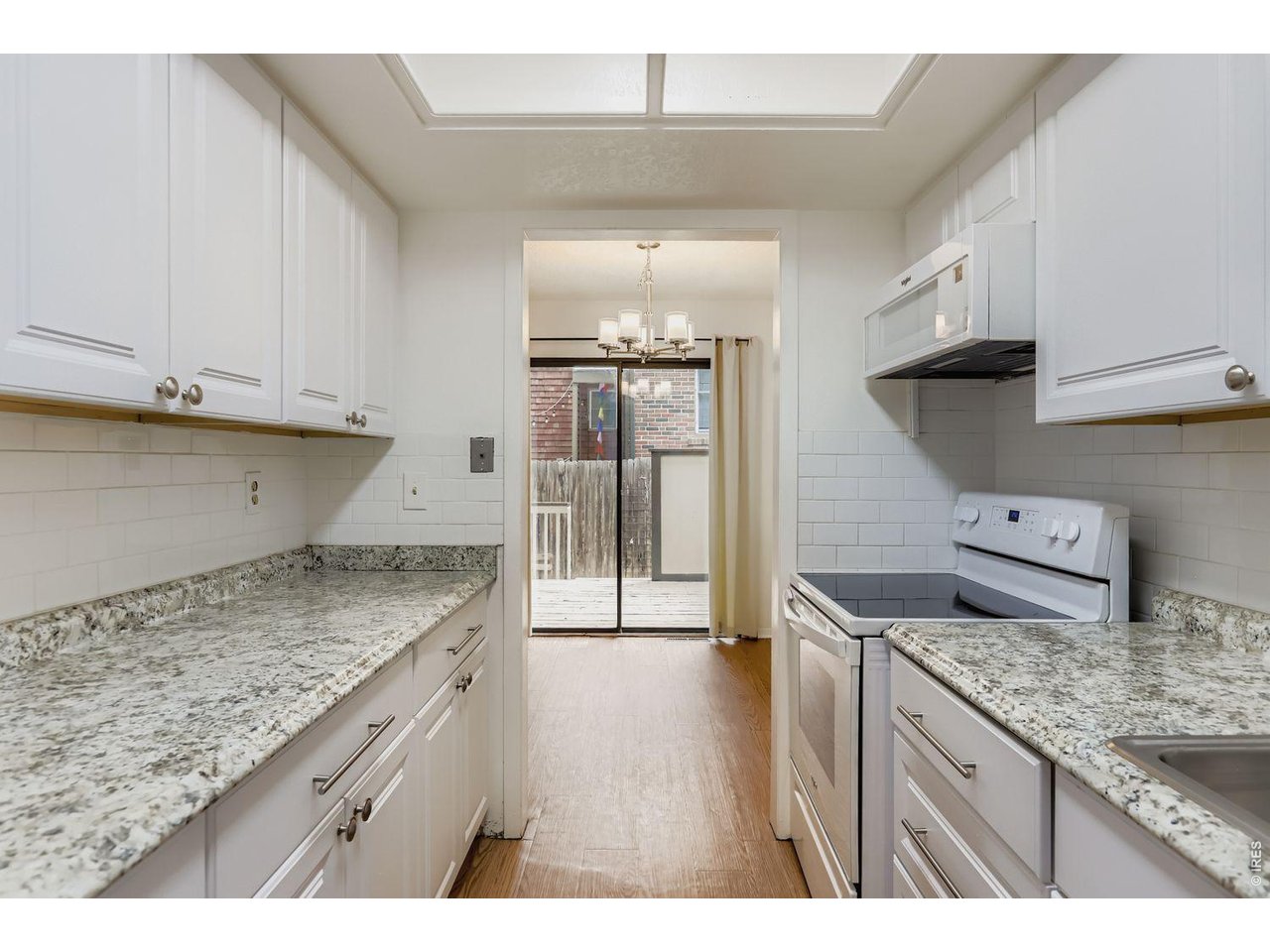 720 17th Street Boulder, CO 80302 - Photo 7 of 35 a kitchen with granite countertop a sink and a stove