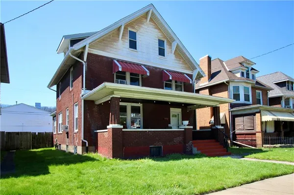 a front view of building with yard