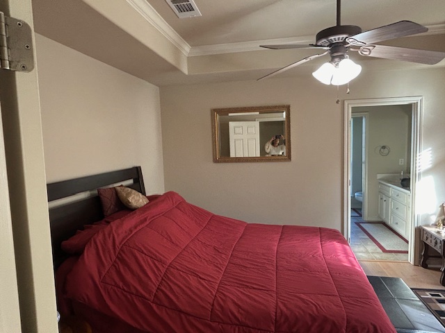 2301 Norham Drive College Station, TX 77845 - Photo 13 of 25 a bedroom with a bed and a chandelier