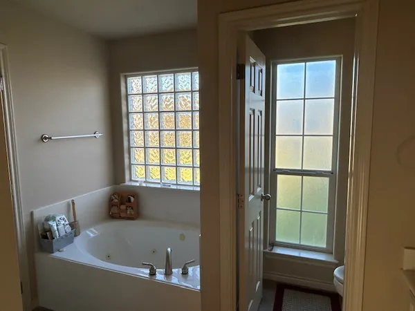 a bath tub sitting in a bathroom next to a window