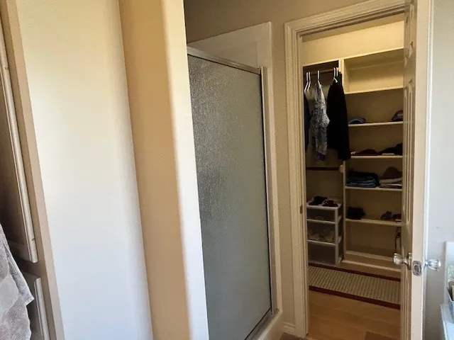 a view of walk in closet with empty racks