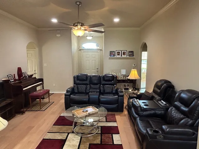 a living room with furniture and a chandelier