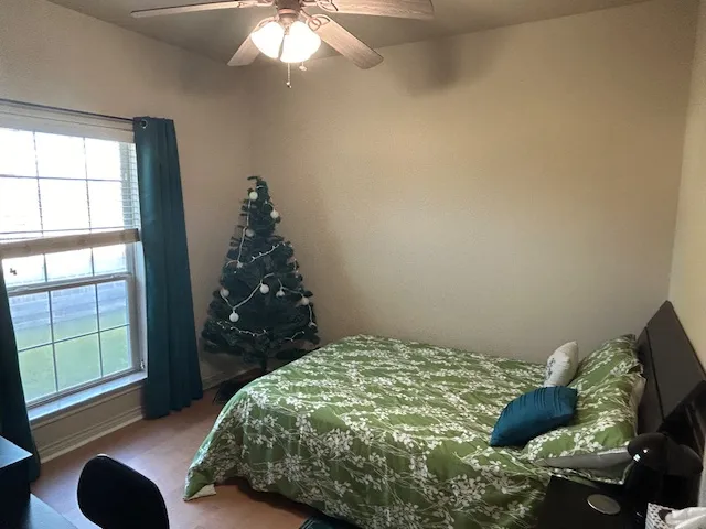 a bedroom with a bed and a window