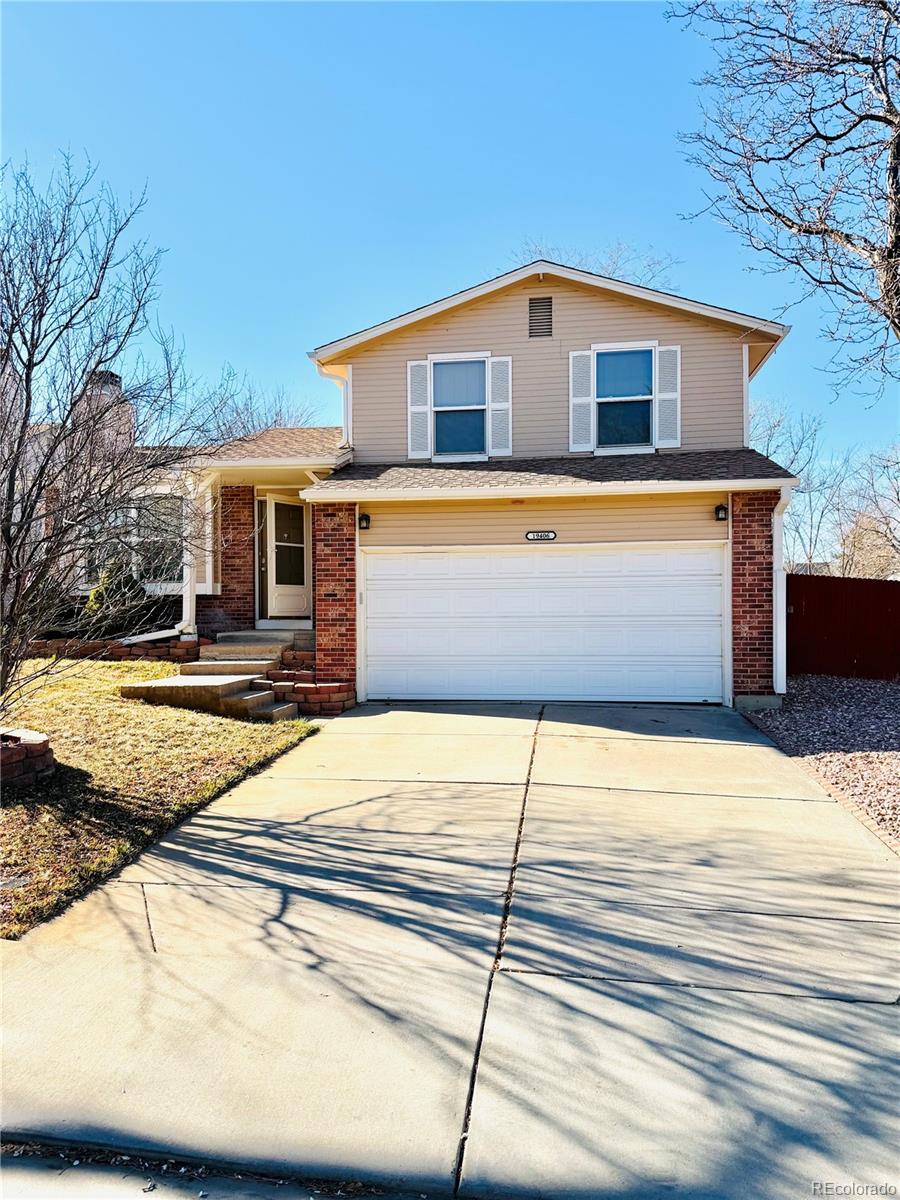 19406 East Purdue Place Aurora, CO 80013 - Photo 1 of 10 a front view of a house with a yard