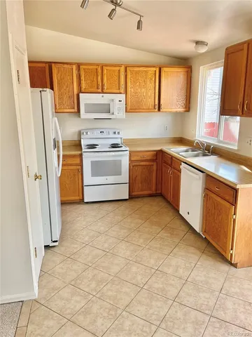 a kitchen with stainless steel appliances granite countertop a refrigerator sink and stove