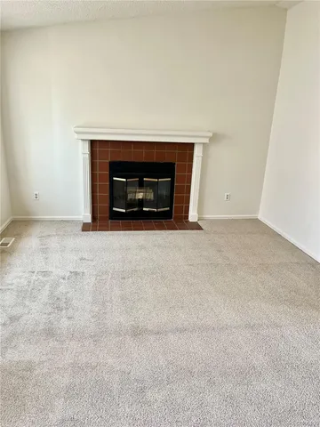a view of empty room with a fireplace