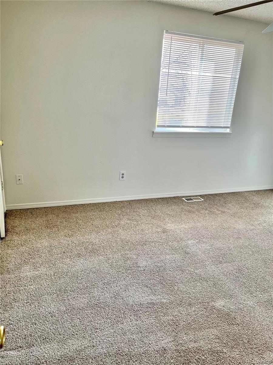 19406 East Purdue Place Aurora, CO 80013 - Photo 4 of 10 an empty room with a window