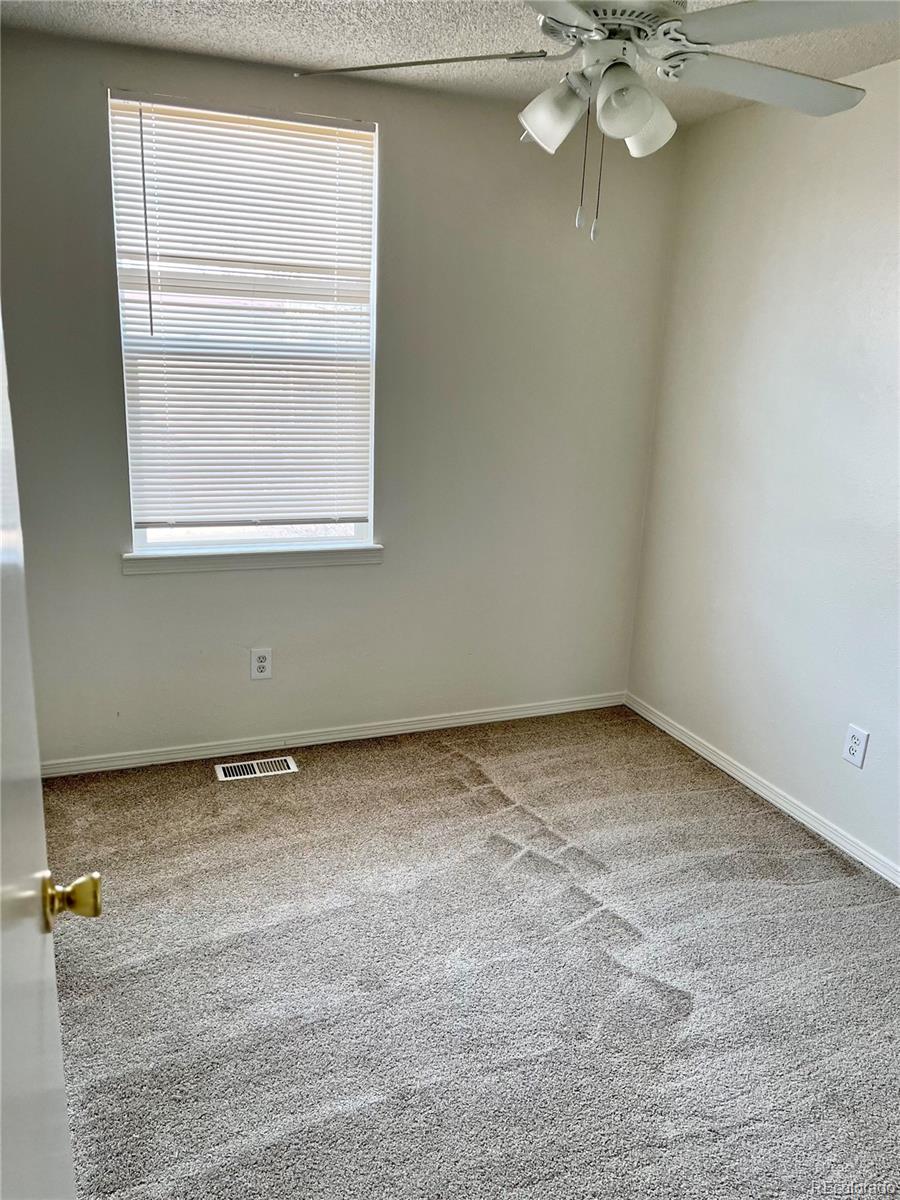 19406 East Purdue Place Aurora, CO 80013 - Photo 5 of 10 an empty room with a window
