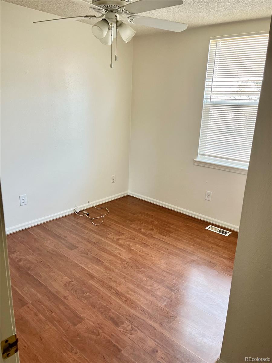19406 East Purdue Place Aurora, CO 80013 - Photo 6 of 10 an empty room with a window