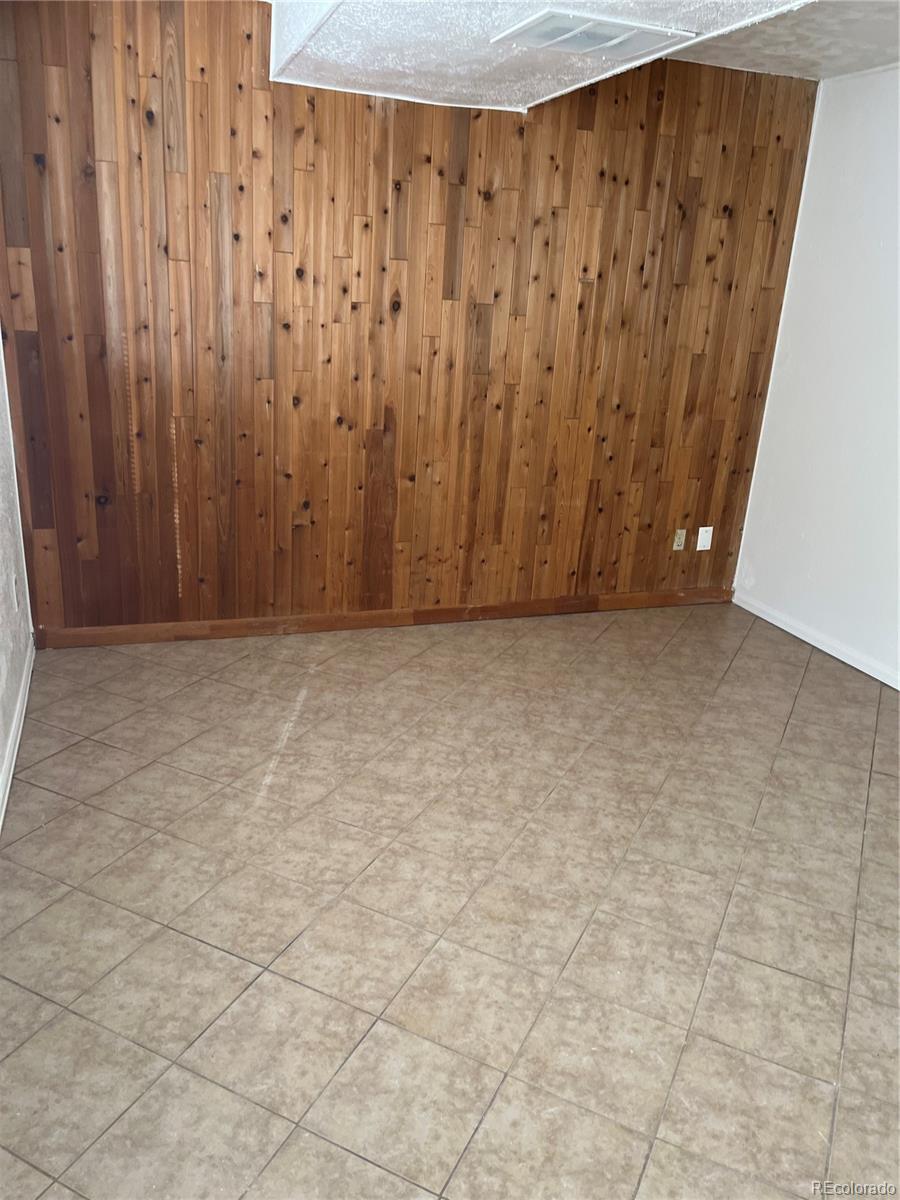 19406 East Purdue Place Aurora, CO 80013 - Photo 7 of 10 a view of a room with wooden walls