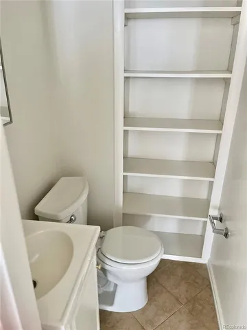 a white toilet sitting next to a shower