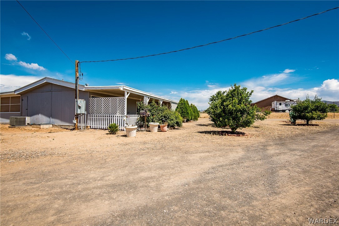 3373 Higley Road Golden Valley, AZ 86413 - Photo 15 of 47 a view of a house with a yard