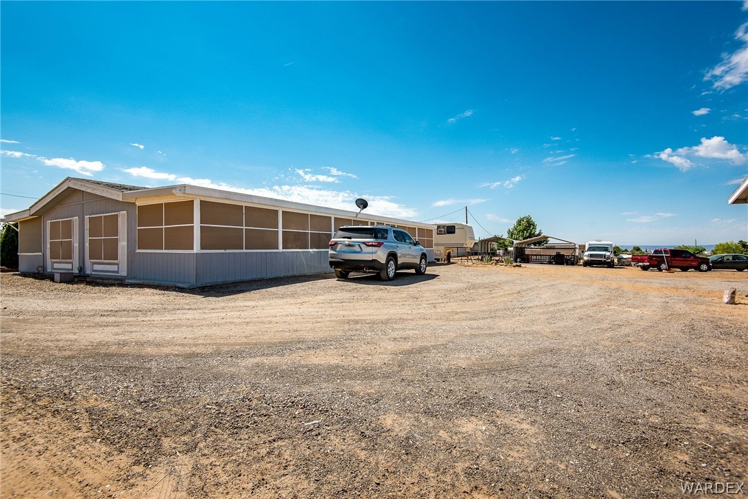 3373 Higley Road Golden Valley, AZ 86413 - Photo 17 of 47 a view of a house with a yard