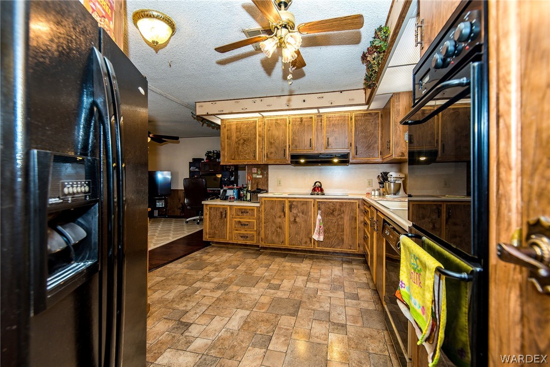 3373 Higley Road Golden Valley, AZ 86413 - Photo 27 of 47 a kitchen with stainless steel appliances a stove a refrigerator and a sink