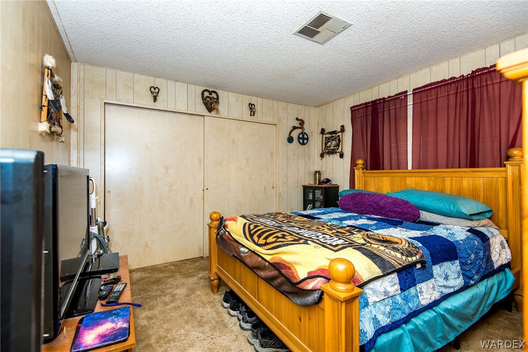 3373 Higley Road Golden Valley, AZ 86413 - Photo 28 of 47 a bedroom with a bed and a dresser