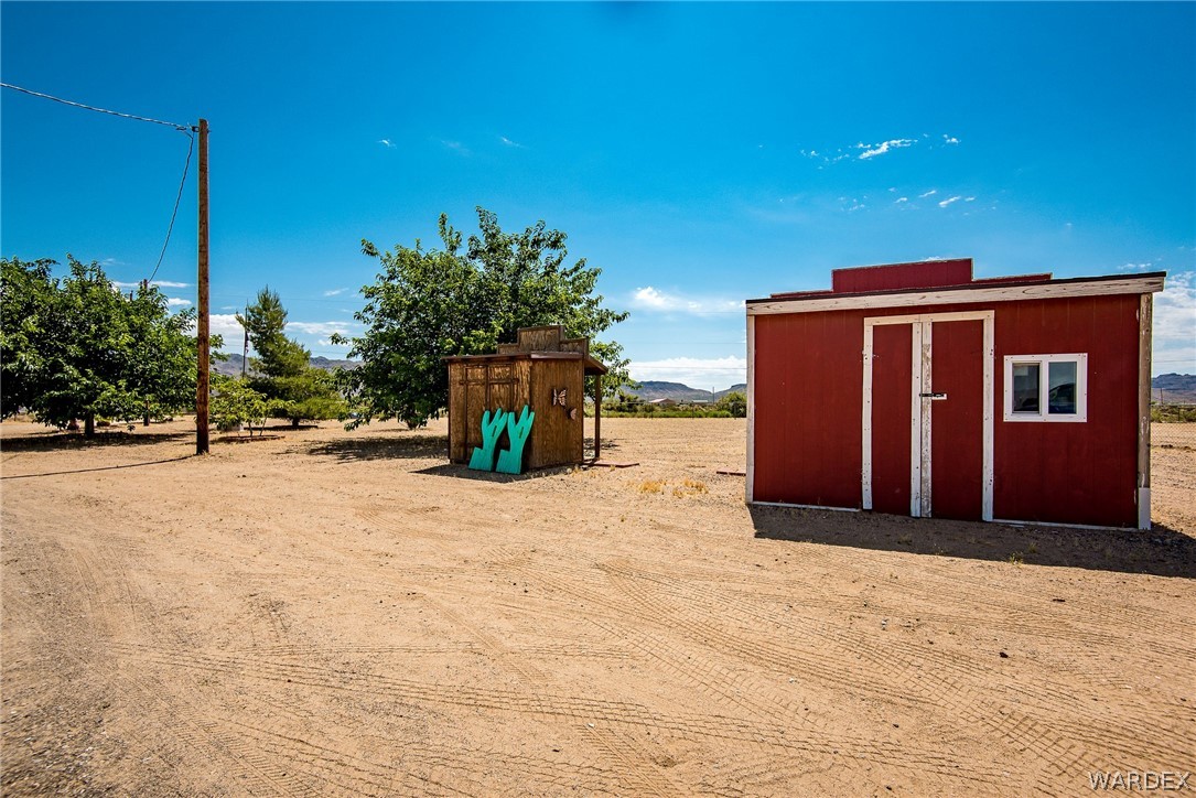 3373 Higley Road Golden Valley, AZ 86413 - Photo 5 of 47 a view of a house with backyard and trees