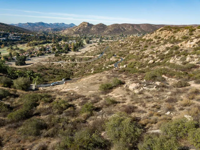 a view of a large building with mountains in the background