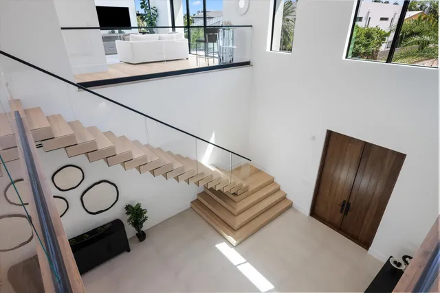 a bed room with large bed and a balcony