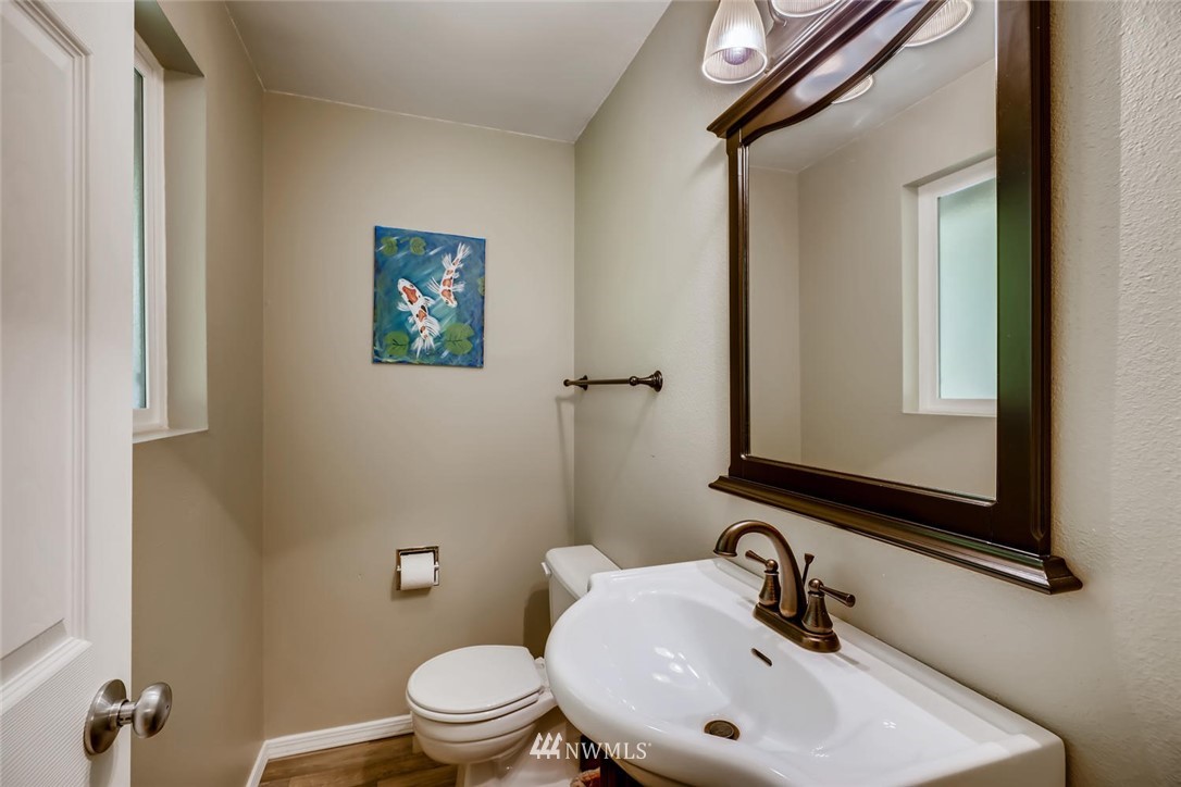 11510 148th Avenue Southeast Renton, WA 98059 - Photo 22 of 37 a bathroom with a sink a mirror and a toilet
