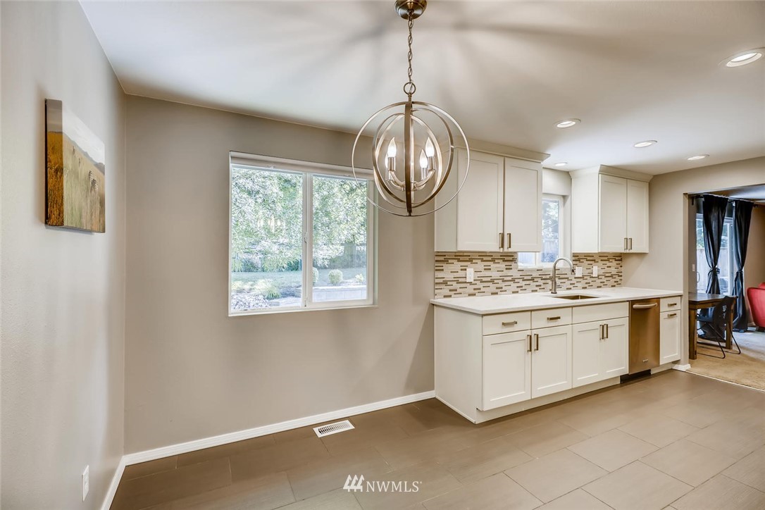 11510 148th Avenue Southeast Renton, WA 98059 - Photo 8 of 37 a view of a kitchen counter space a sink and a chandelier