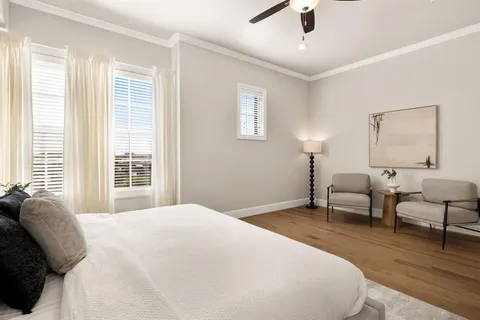 a spacious bedroom with a bed and a couch