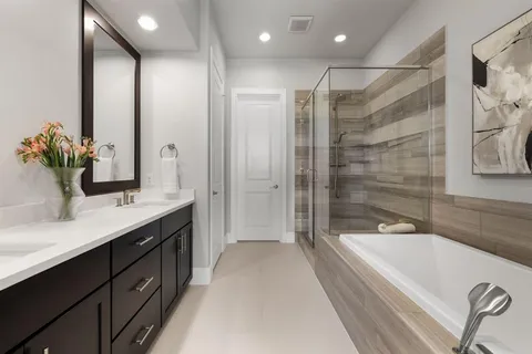 a bathroom with a bathtub shower sink double and mirror