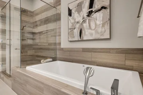 a bathroom with a bathtub and shower