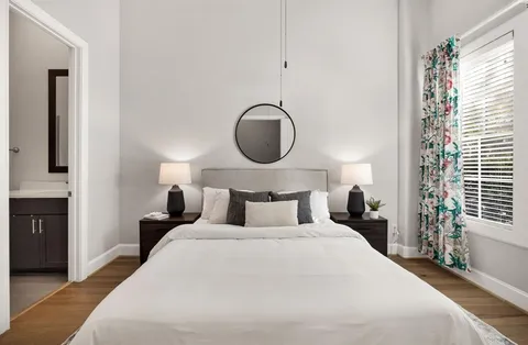 a bedroom with a large bed and a large window