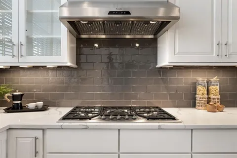 a kitchen with a stove and cabinets