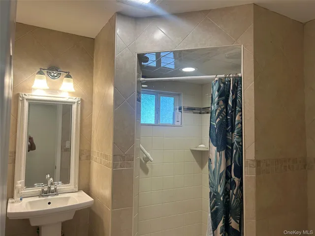 a bathroom with a sink a mirror and a shower