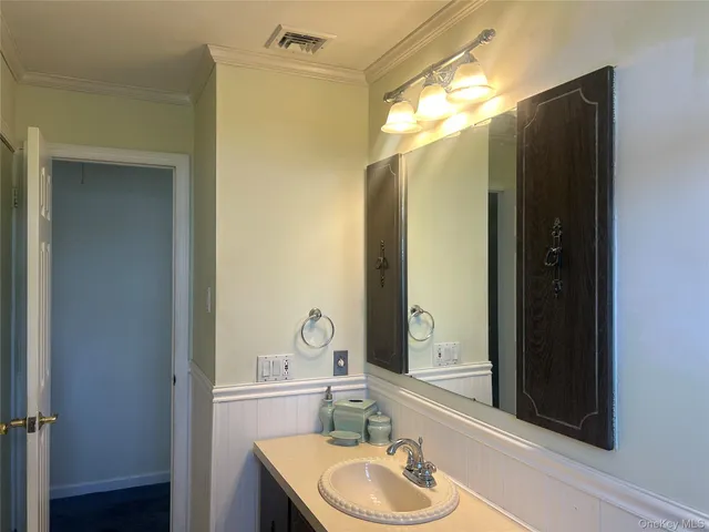 a bathroom with a sink vanity granite tub and shower