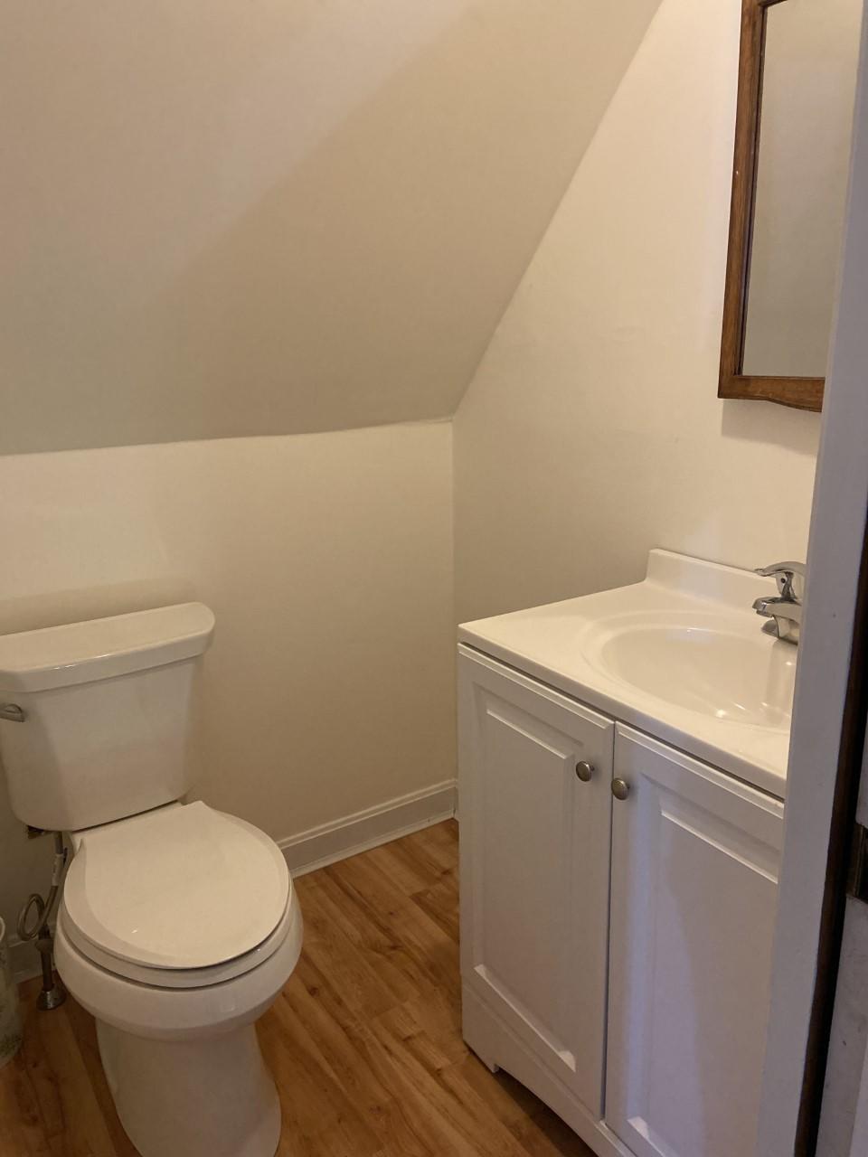 170 Taramac Road Centerville, MA 02632 - Photo 12 of 20 a bathroom with a toilet a sink and wooden floor